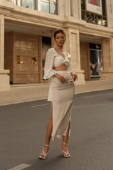 High-waisted silk midi skirt with side slits and sleek tailored silhouette for modern elegance